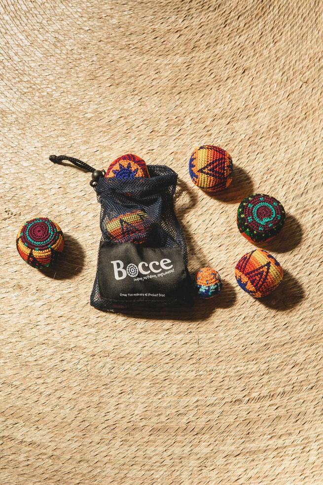 A bocce ball set on a wooden background