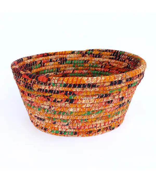 A multicolored laundry basket made from recycled materials, featuring a pattern of various colors and textures.