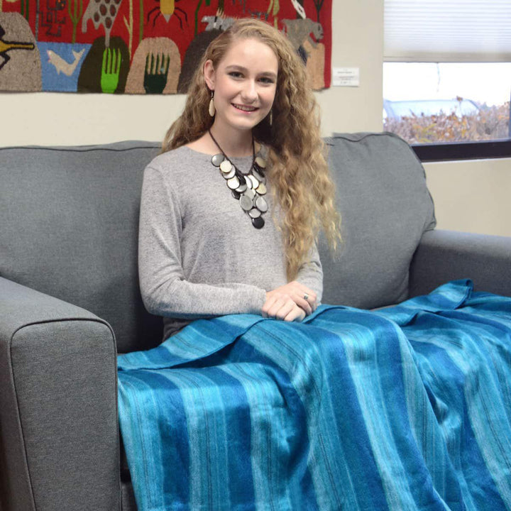 a women wrapped in a brushed acrylic lap blanket