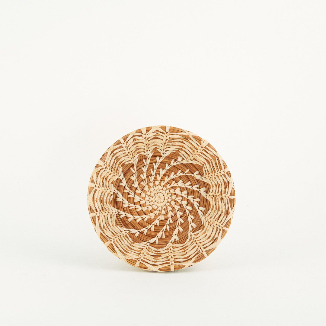 Handmade woven basket with brown and light beige spiral patterns