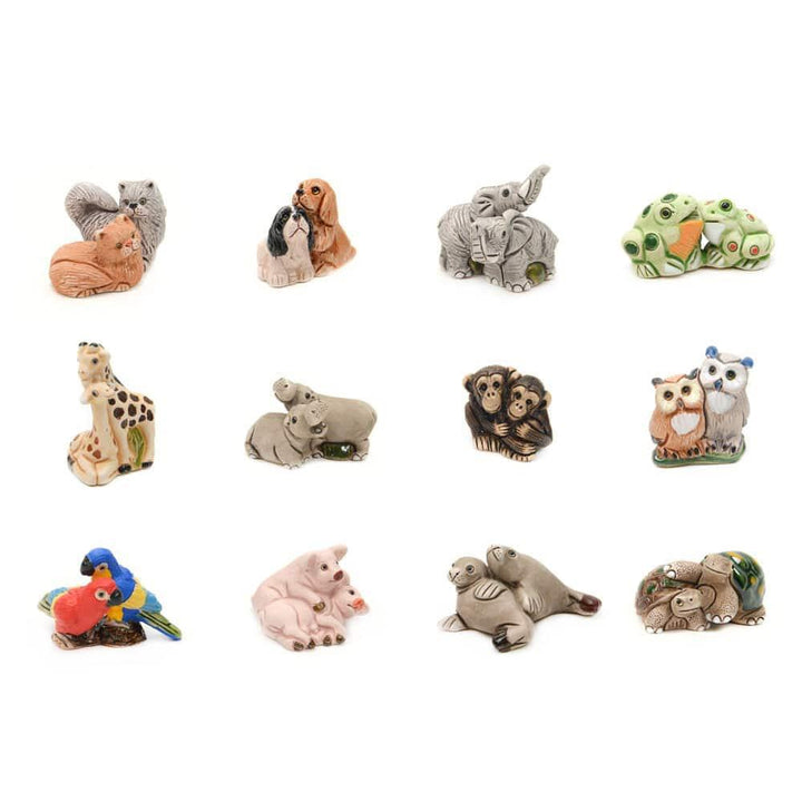 A collection of ceramic animal duo figurines, including a variety of wildlife on a white background.