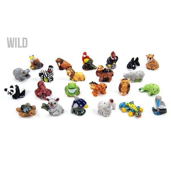 A collection of small, colorful ceramic animal figurines, each with a unique design, arranged on a surface.