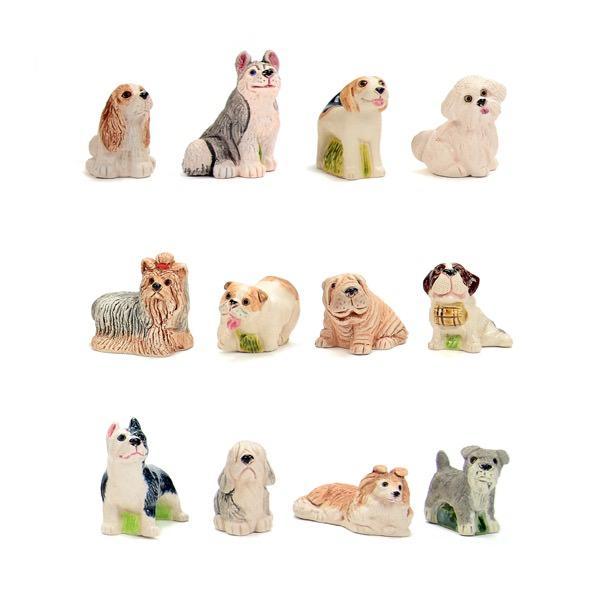 A set of ceramic pet figurines, including both dogs  in various colors and poses.