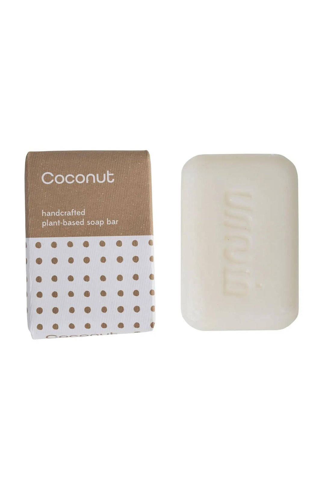 A bar of coconut soap next to its cardboard packaging, both with the brand name 'The Work of Our Hands' printed on them.