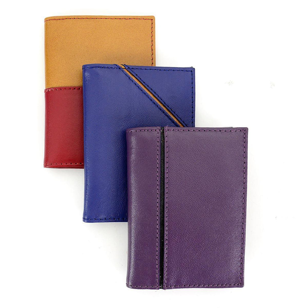 A collection of three leather card holders in red, blue, and purple colors, with card slots visible.