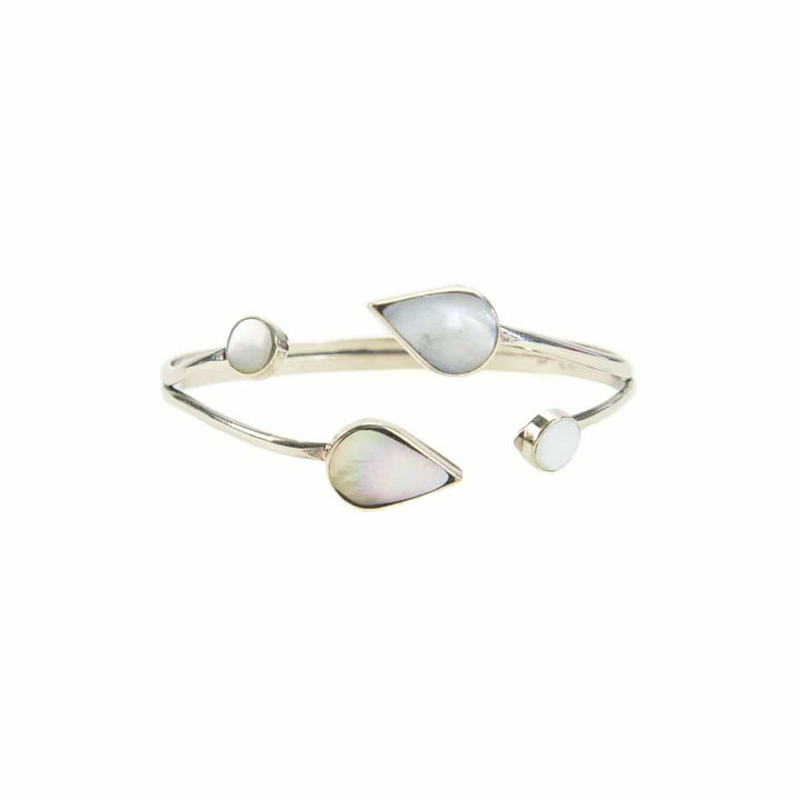 A silver bracelet with mother of pearl stone leaves on a white background.
