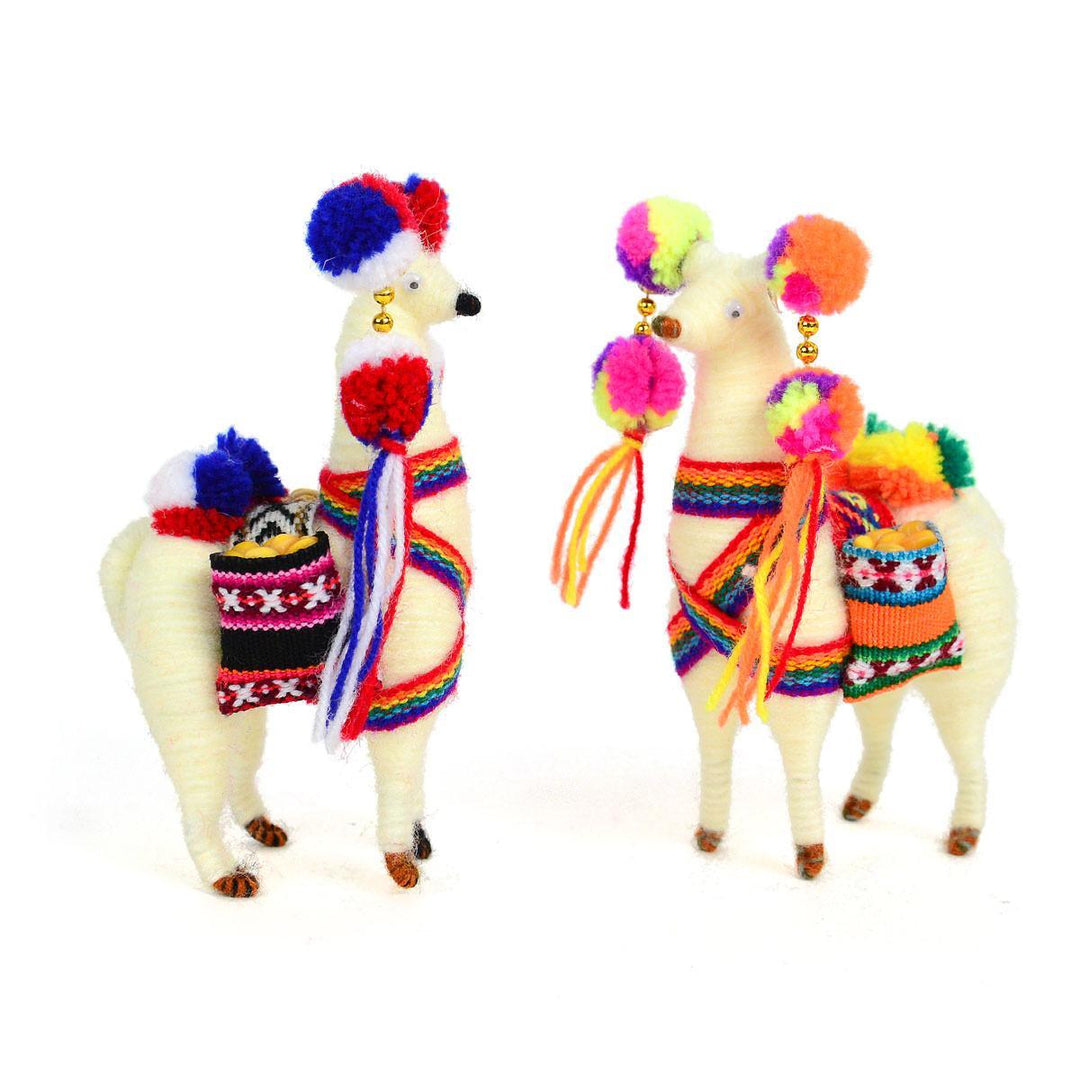 Two decorative llamas wearing colorful traditional Peruvian clothing, with one llama facing away from the camera showing the back side. The llamas have alpaca yarn and acrylic details.