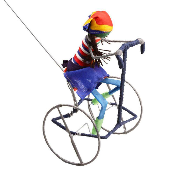 A girl galimoto toy riding a bicycle on a white background