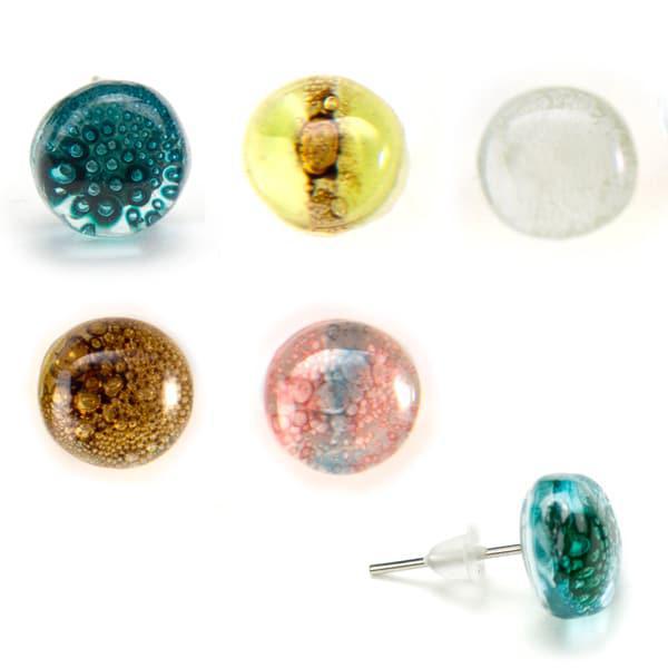 A collection of various glass stud earrings in different colors and patterns, displayed in rows. They come in various shapes including square, round, and triangular, and are attached to metal posts.