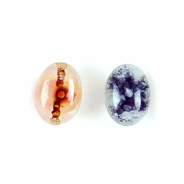 A collection of various glass stud earrings in different colors and oval.