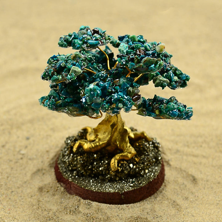a decorative chrysocolla stone tree with a circular base 