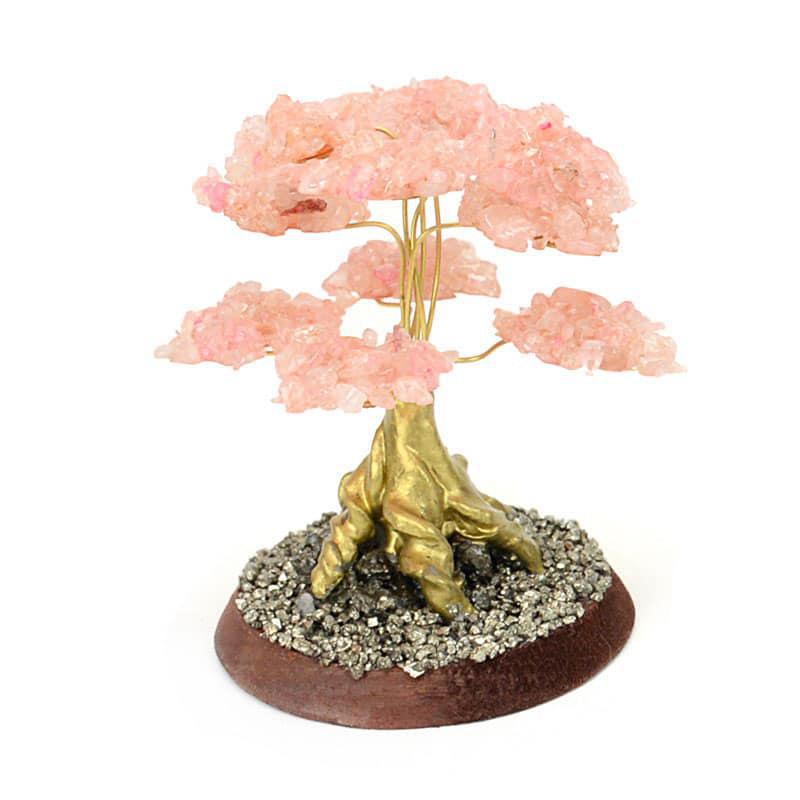 A decorative rose quartz tree with a circular base 