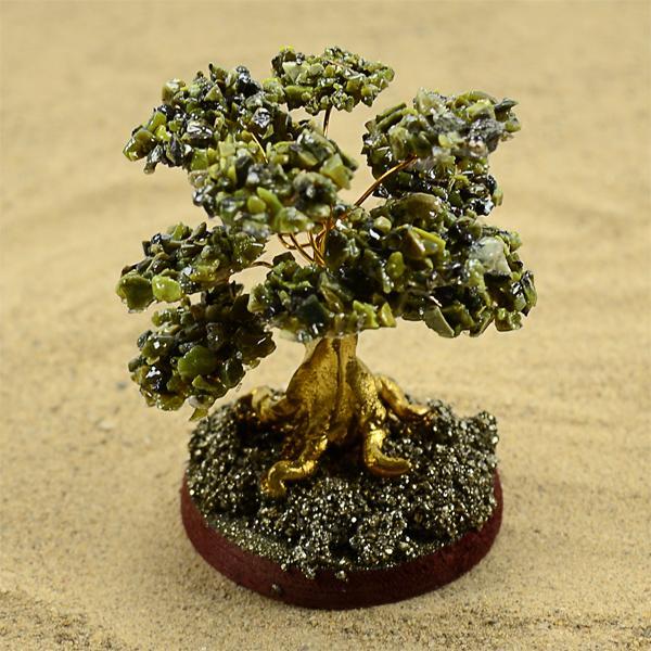 a serpentine stone decorative tree on a circular base. 