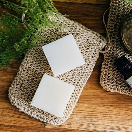 soap on top of hemp soap bag on a wooden background