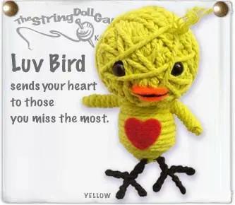 Handmade yellow bird string doll with large red heart on it's torso.
