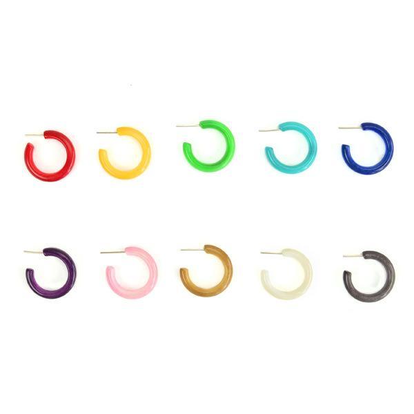 A collection of colorful hoop earrings made from tagua nut, displayed in a gradient of colors ranging from red, green, blue, purple, brown, and clear.