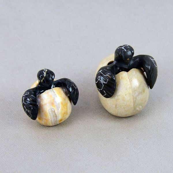A pair of decorative turtle-shaped bowls made of marble and onyx, with one turtle in a speckled egg pattern and the other in a solid black and gray color.