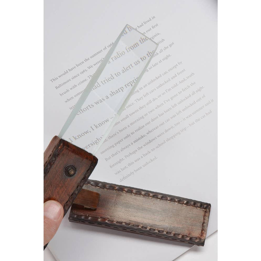 News reader magnifying glass on a book page. 