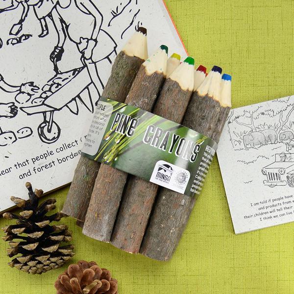 A bundle of pine stick crayons displayed next to a coloring book and pencils.