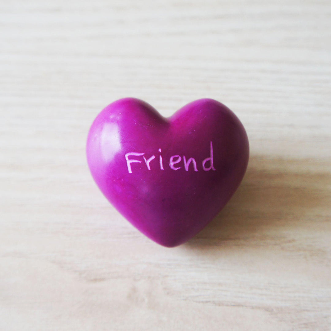 A pink kisii friend heart on a wooden background 