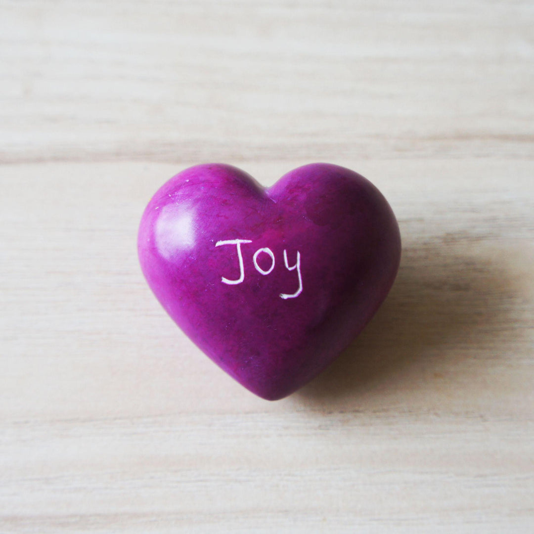 a purple kisii joy heart on a wooden background 