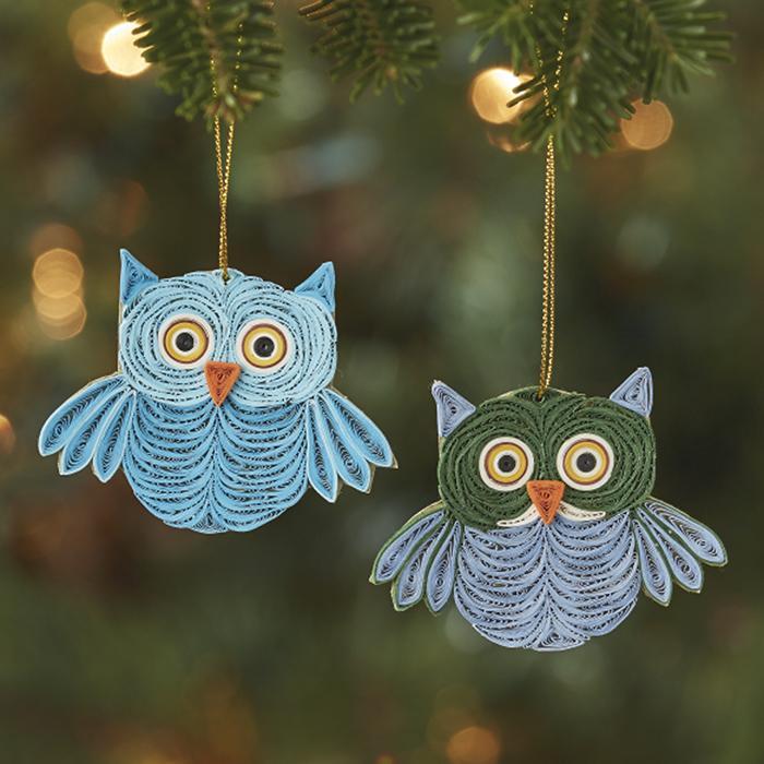 quilled owl ornaments on a green background