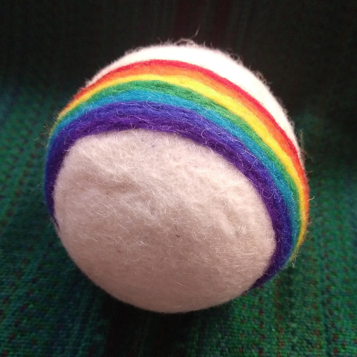 rainbow dryer ball on a green knit backgound