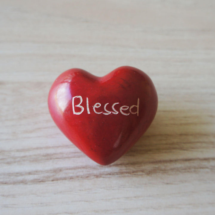 A red kisii blessed heart on a wooden background