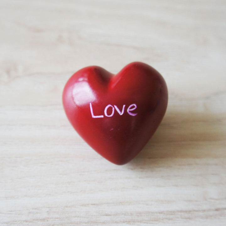 A red kisii love heart on a wooden background