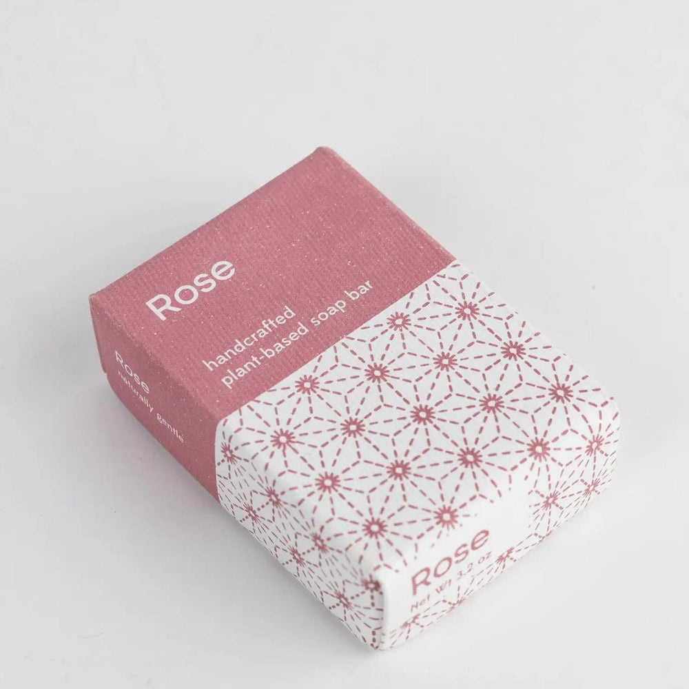 Rose soap in a pink and white patterned box on a white background