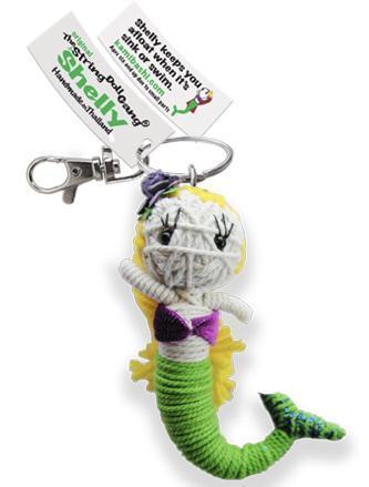 A handcrafted string doll resembling a mermaid with a predominantly green tail, wearing a purple shell bra. The doll is displayed with a nametag and has a keyring attachment.