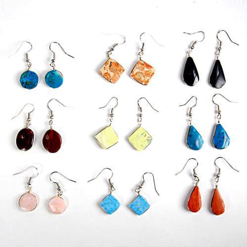 A collection of semi-precious stone earrings in various colors, including blue, red, orange, yellow, and purple, crafted with silver hooks.