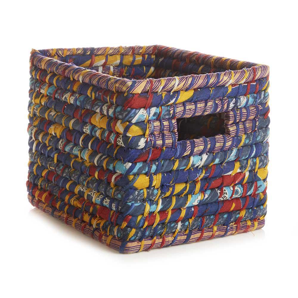 A blue and yellow sari wrapped basket on a white background