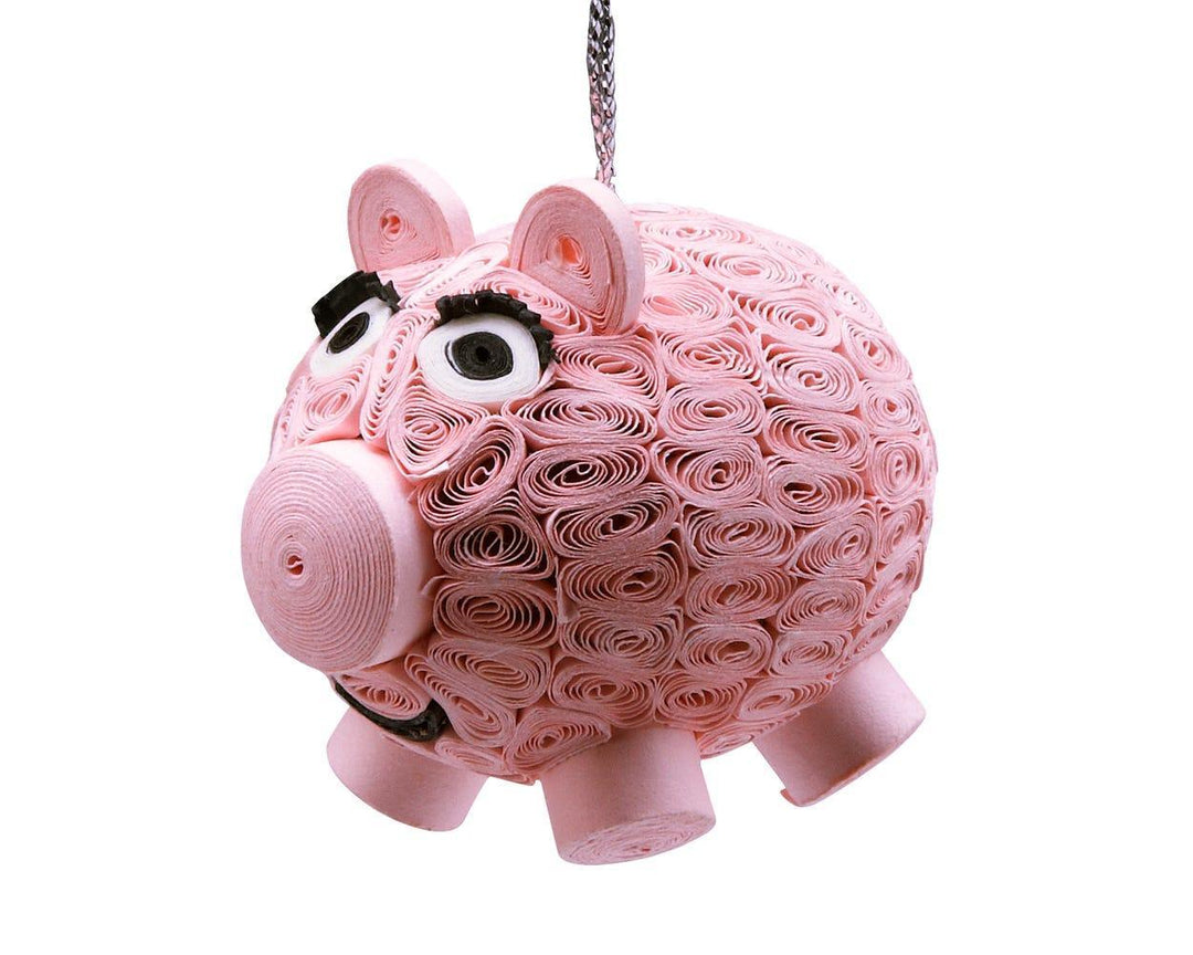 A smiling pig ornament on a white background