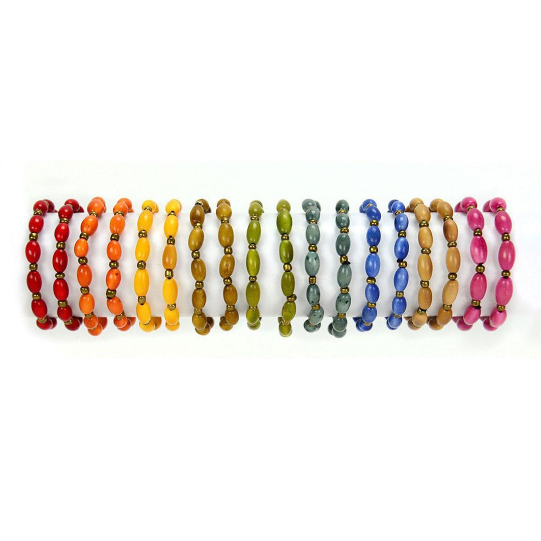 A colorful bracelet made with tagua nuts and brass beads, displayed on a white background.