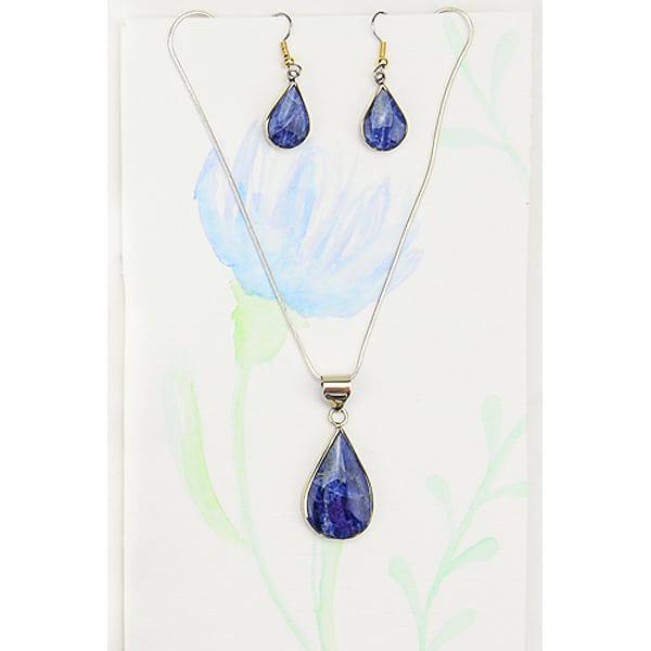 A set of blue teardrop-shaped earrings attached to a silver-colored necklace, displayed against a floral background.