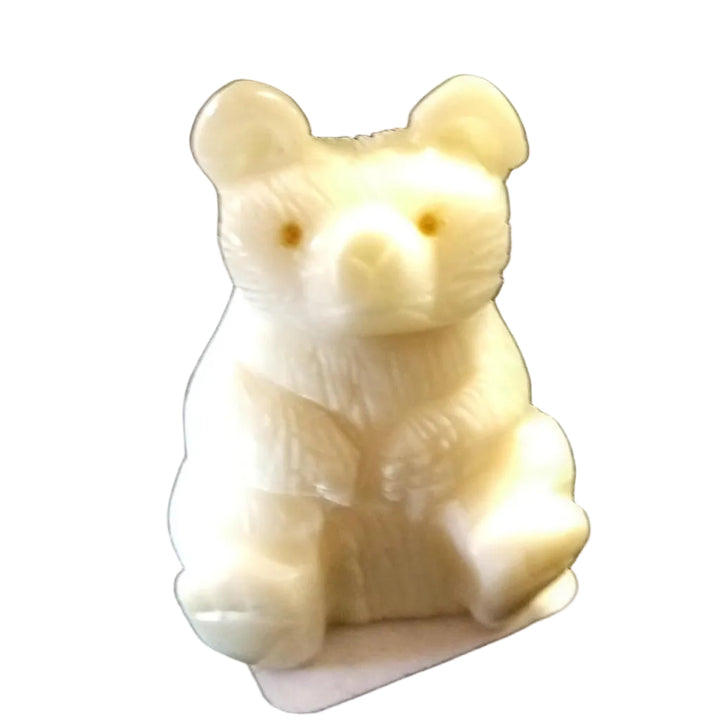a tagua nut bear sitting on a white background