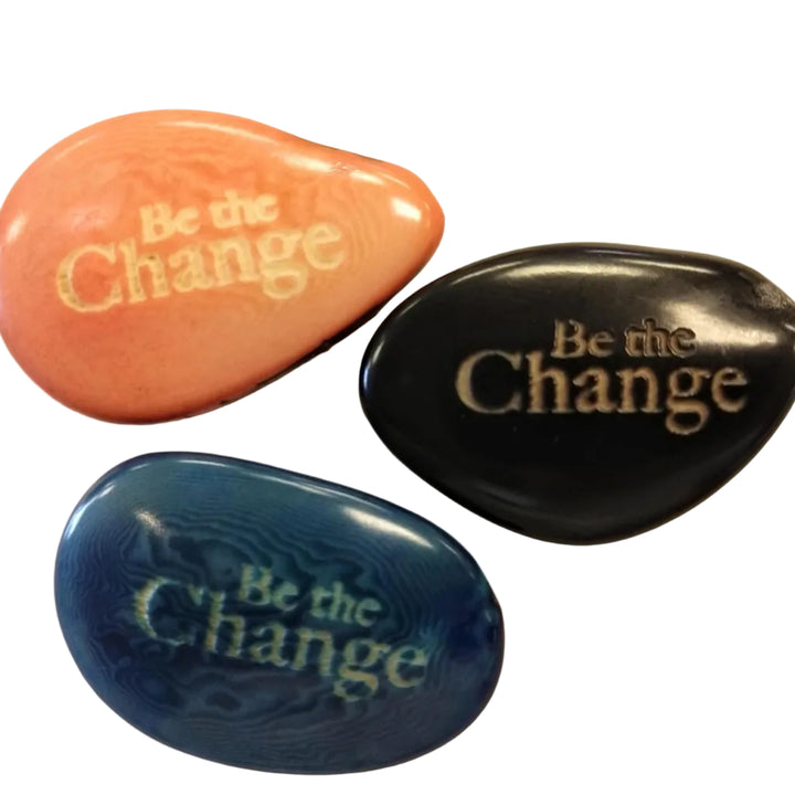 three tagua nuts with the phrase 'be the change'
