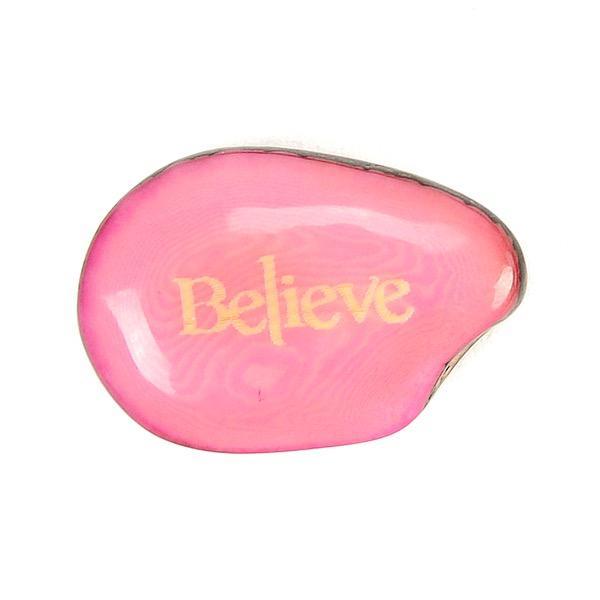 a pink tagua nut with the word 'Believe'