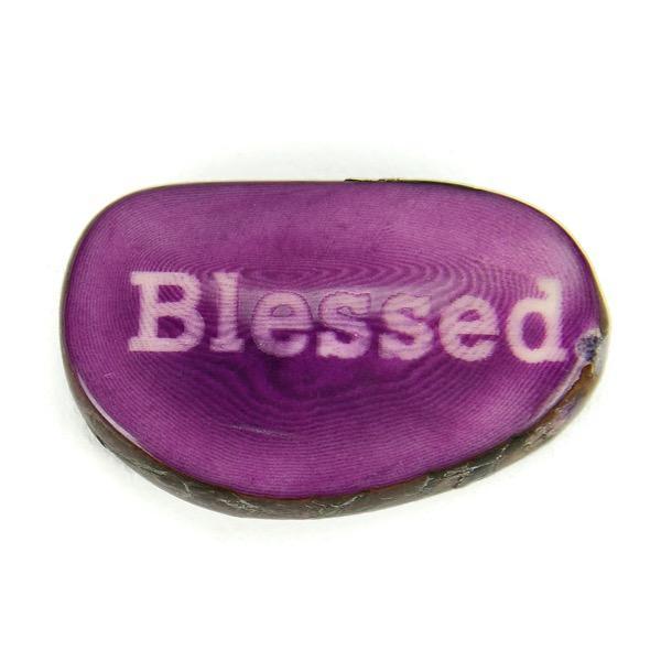 a tagua nut with the word 'blessed'