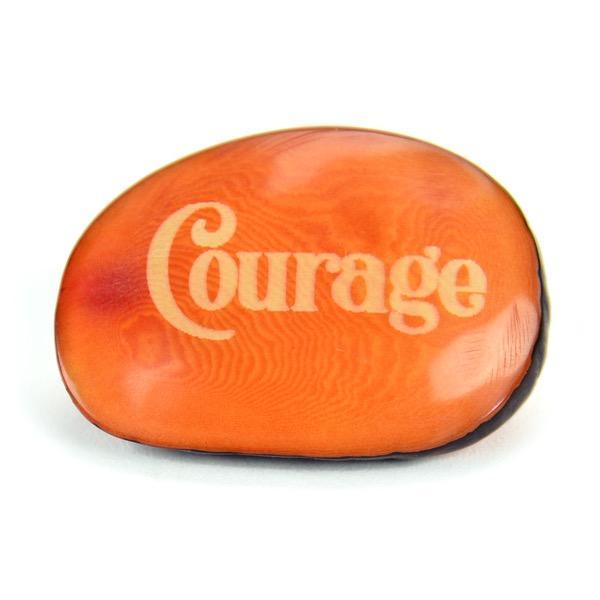 a tagua nut with the word 'courage'