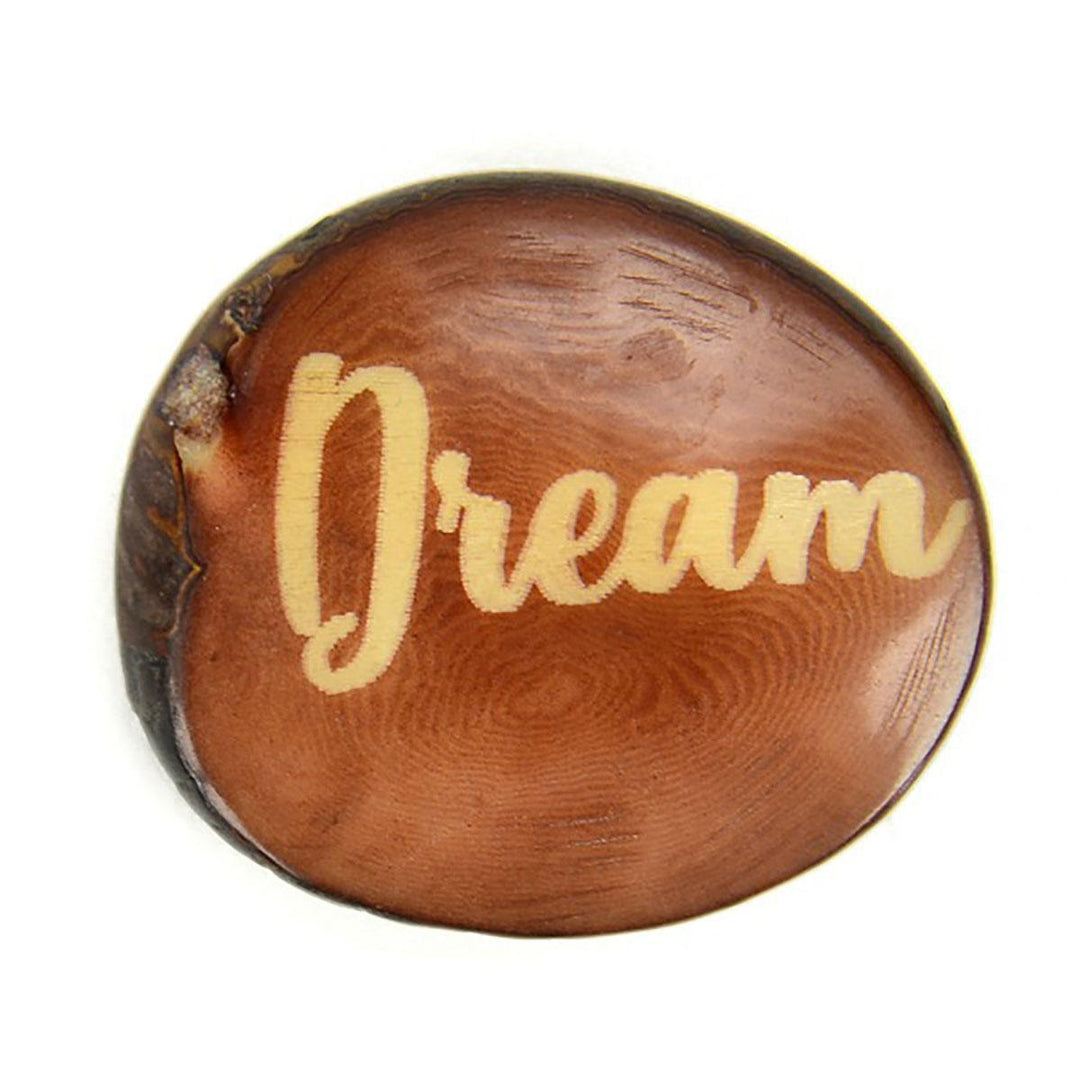 a brown tagua nut with the word 'dream'
