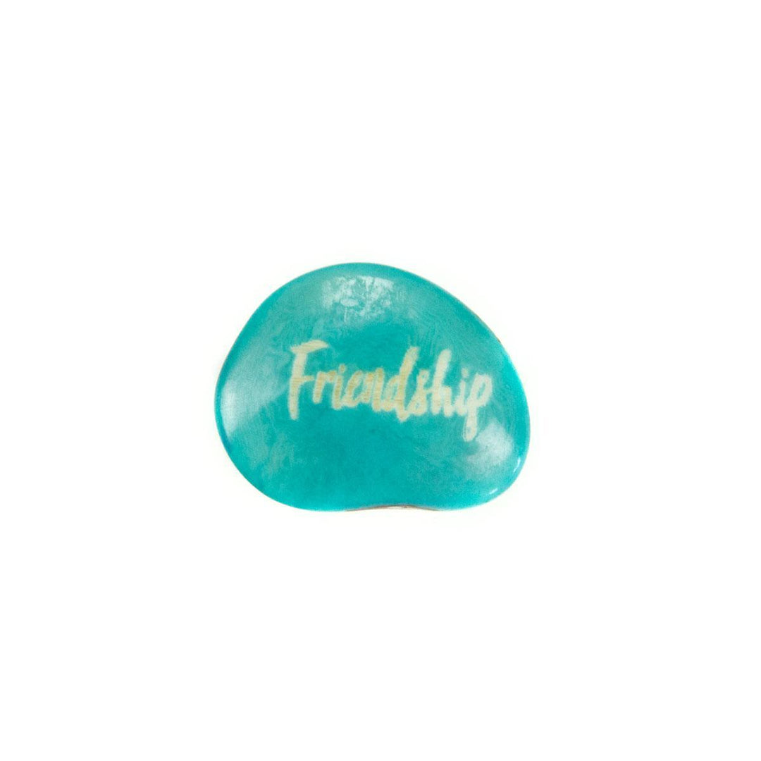 an aqua tagua nut with the word 'friendship'