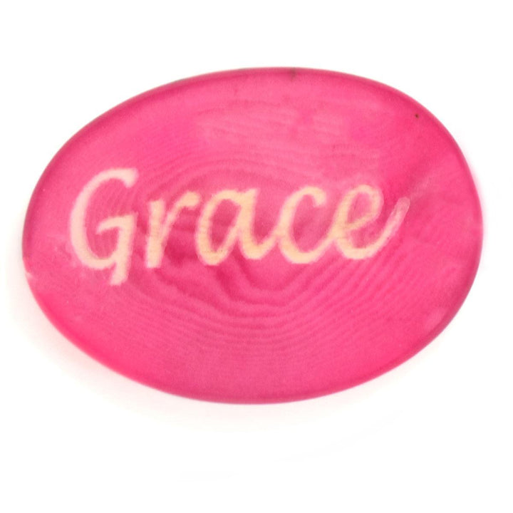 a pink tagua nut with the word 'grace'