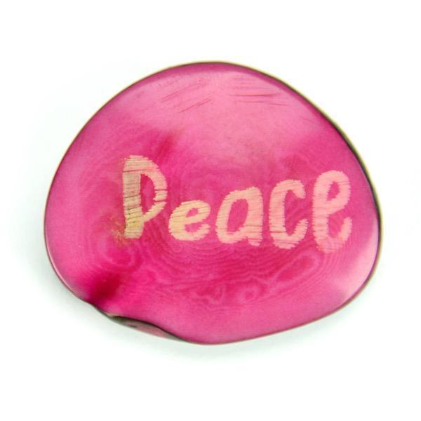 a Tagua nut with the word "peace"