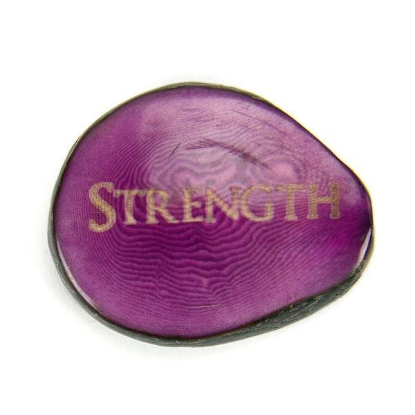 Purple tagua nut with the word "strength"
