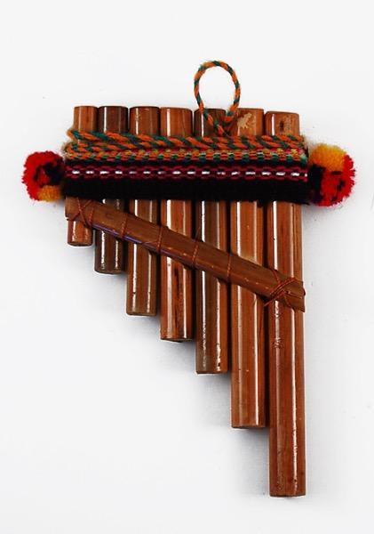 A traditional Andean pan flute made of bamboo with cotton wrapping and a colorful striped fabric attached to the top, handcrafted in Peru.