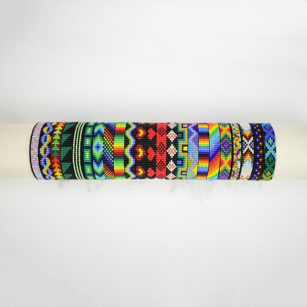 Multicolored woven bead bracelet displayed, with a variety of colorful beads and patterns.